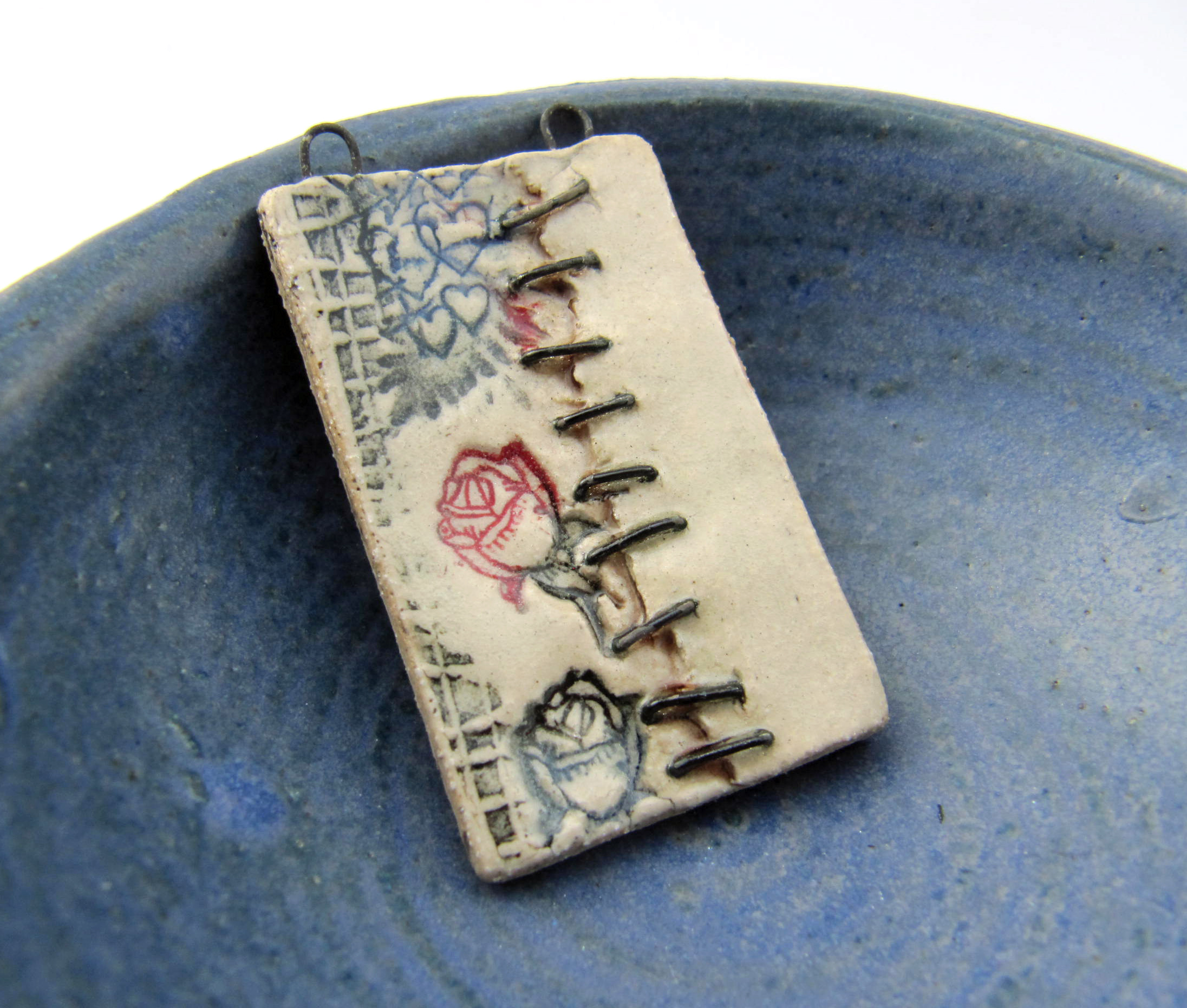 peeling paper stapled pendant 1