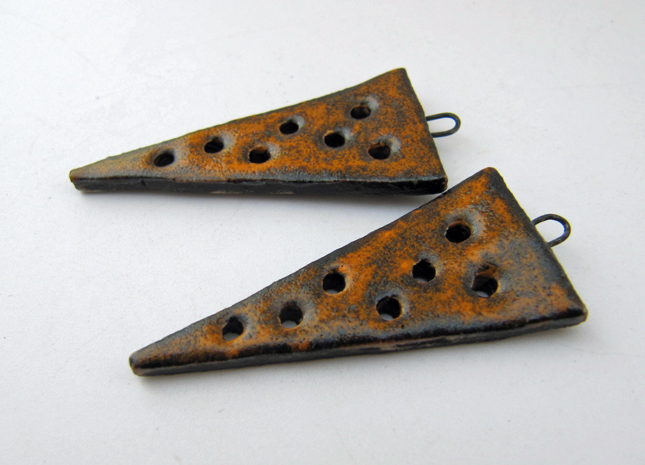orange glow pierced triangle charms